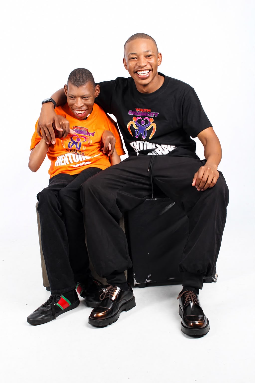 Seabelo Mabitsela with his brother Khaya Mabitsela, both wearing Youth Disability Talk Out shirts.